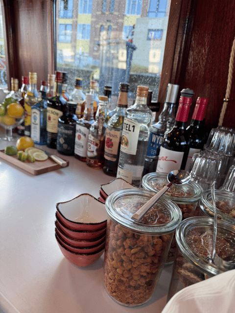 Amsterdam: Historic Boat Cruise with open bar and nibbles - Indoor shelter, outdoor views, and Dutch weather