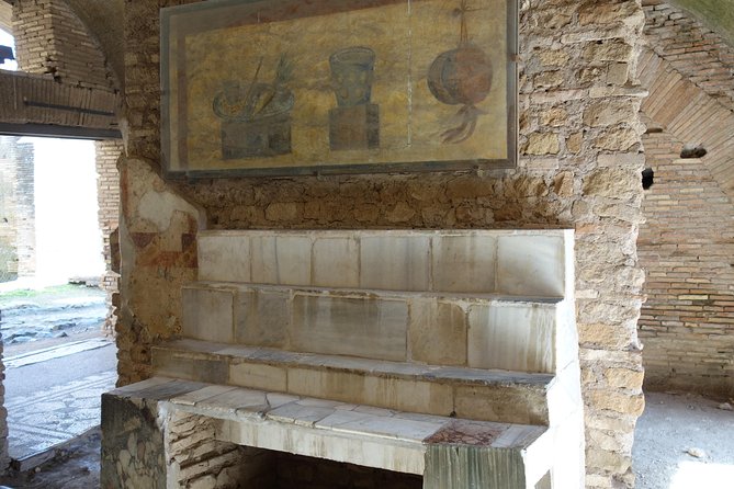 Ancient Ostia Antica Semi-Private Day Trip from Rome by Train with Guide - Shops, apartments, temples, and the Forum of the Corporations
