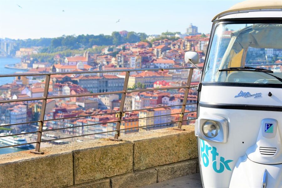 From Leixões: Private Porto Historic Center Tuk Tuk Tour - A glass of Port with Porto across the water
