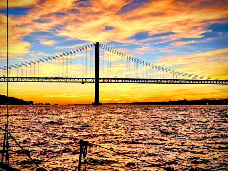 Lisbon: Daytime or Sunset Boat Cruise with History and Wine - Passing beneath the 25 de Abril Bridge