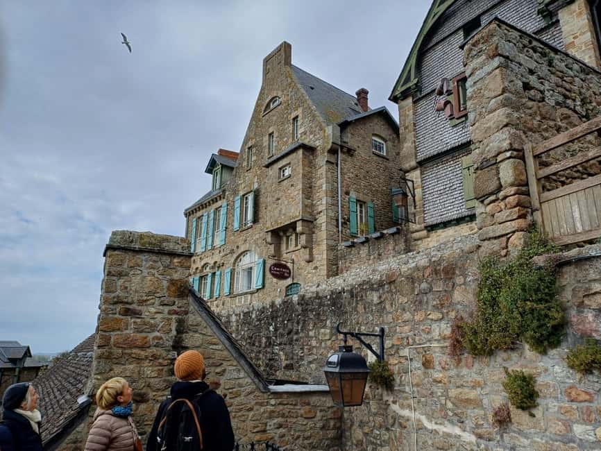 Mont Saint Michel: Village History and Legends Walking Tour - Entering the village through stories and steep lanes